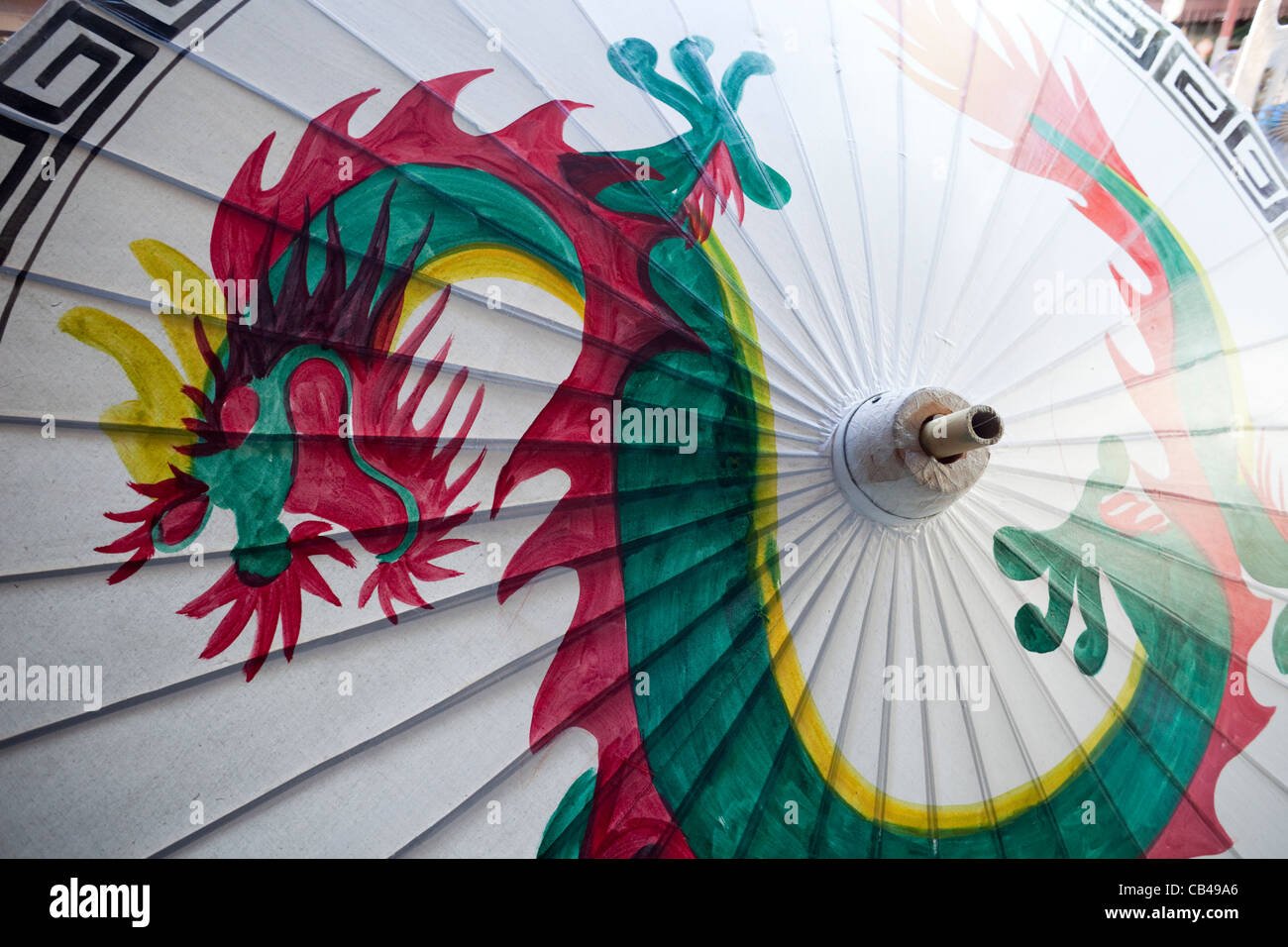 Thailand, Chiang Mai, Borsang Umbrella Village, Artwork of Dragon on Giant Umbrella Stock Photo