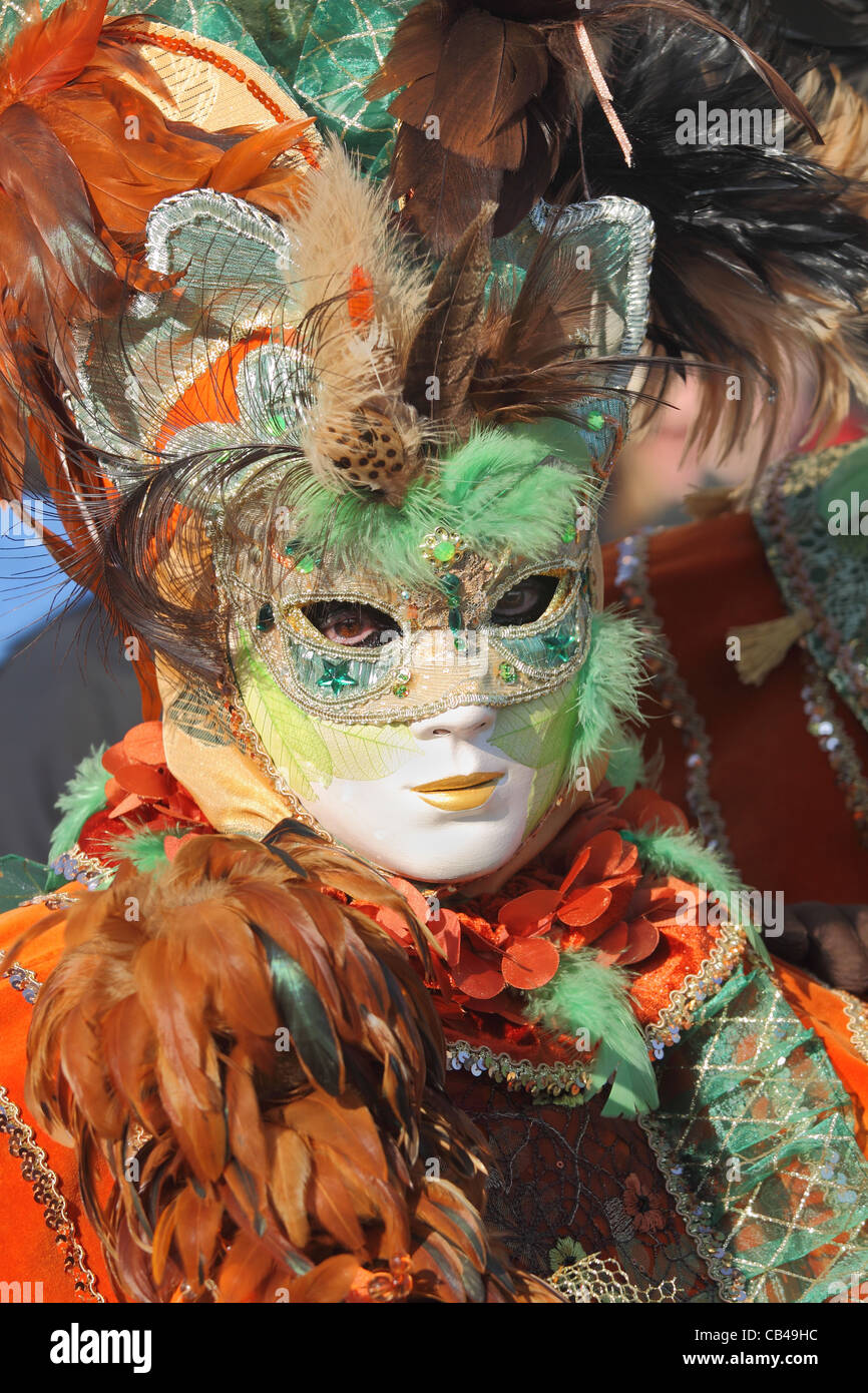 Unidentified participant wear traditionall mask and clothing during famous Venetian Carnival. Stock Photo