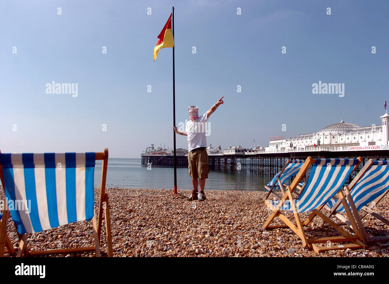 Mark McGowan from London prepares to leave Brighton beach this morning cartwheeling his way to London with sticks of rock UK Stock Photo