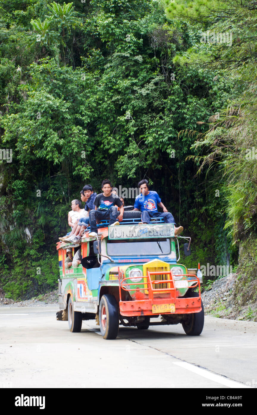 an overloaded jeep with passengers sitting on top of jeep, in mountain province of philippines Stock Photo