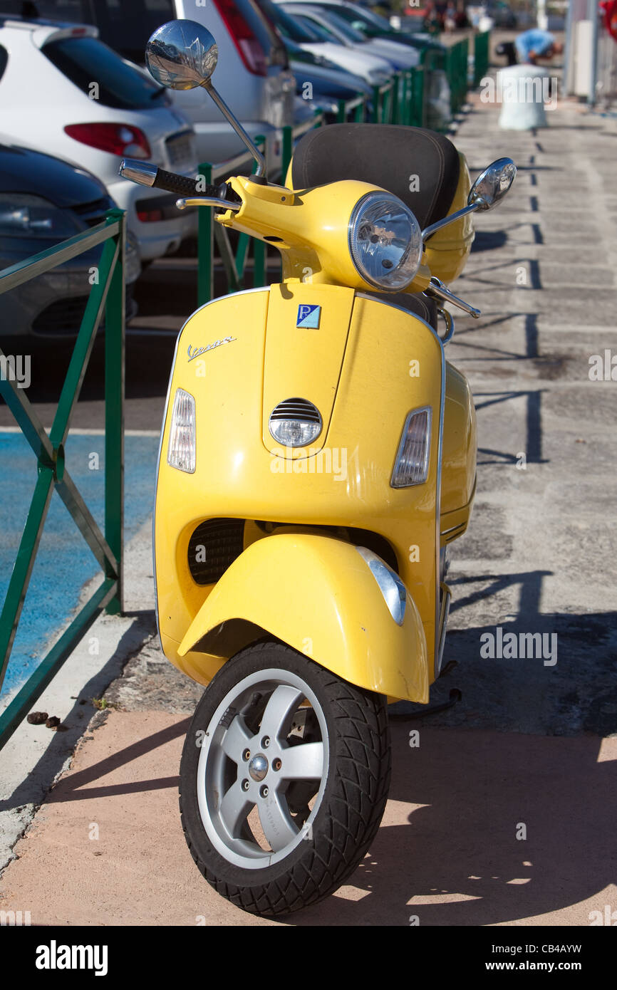 Vespa motor scooter on jetty at harbour .Ajaccio Corsica Stock Photo
