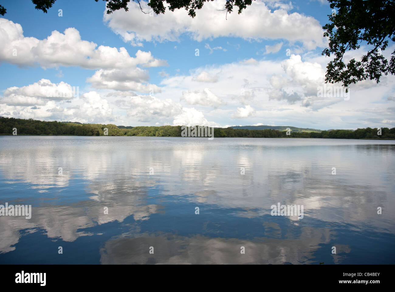 Reflections of the sky on lake Gué-de-Selle near Mézangers in the Mayenne department of Pays de la Loire, France Stock Photo