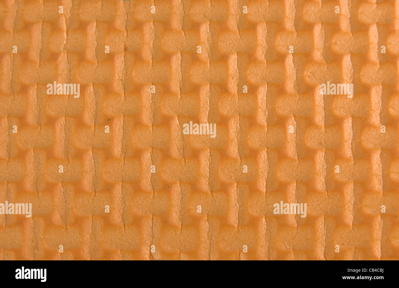 Orange woven rubber texture macro shot. Useful as background for design. Stock Photo