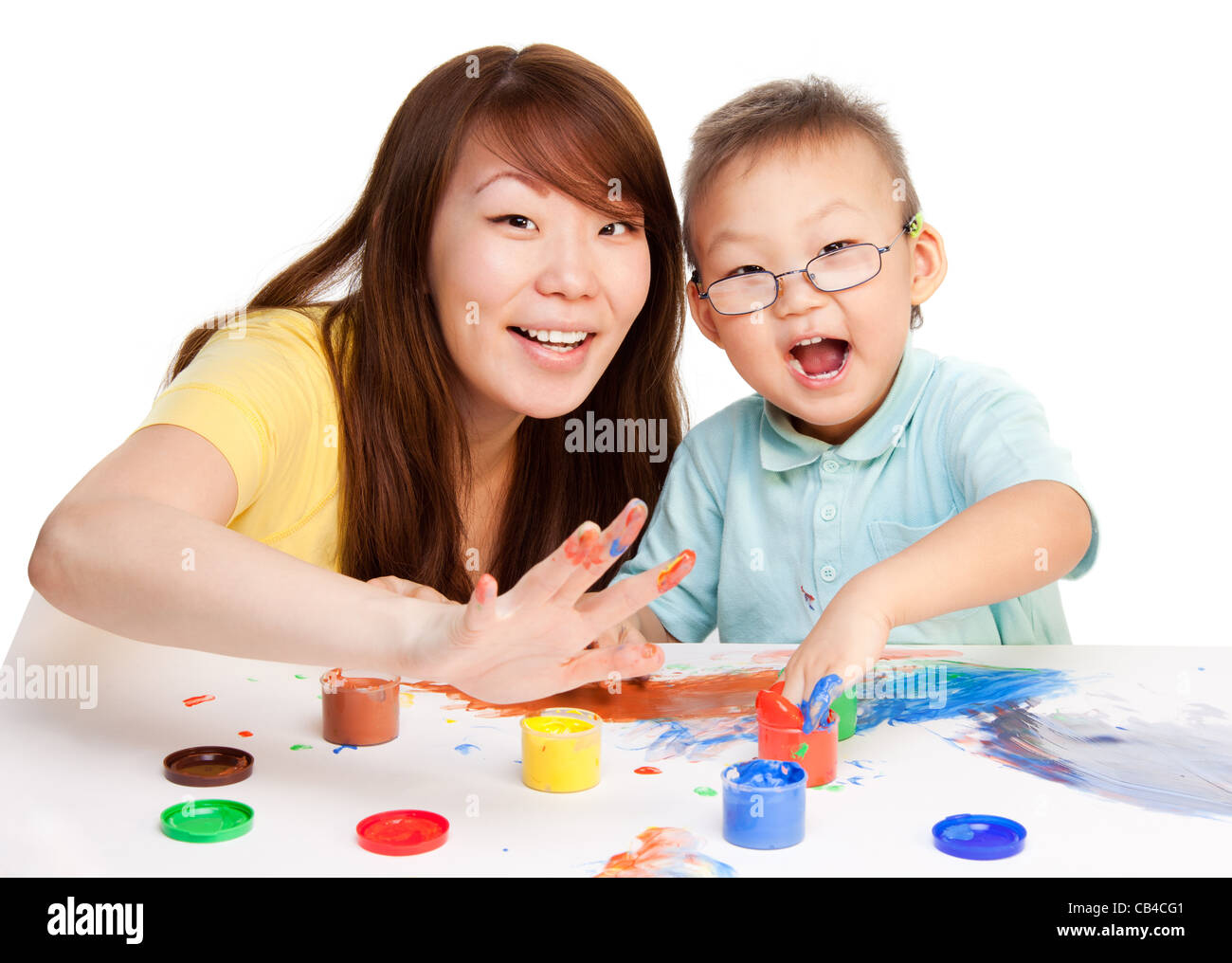 Mother and kid spending some time together painting with their hands Stock Photo