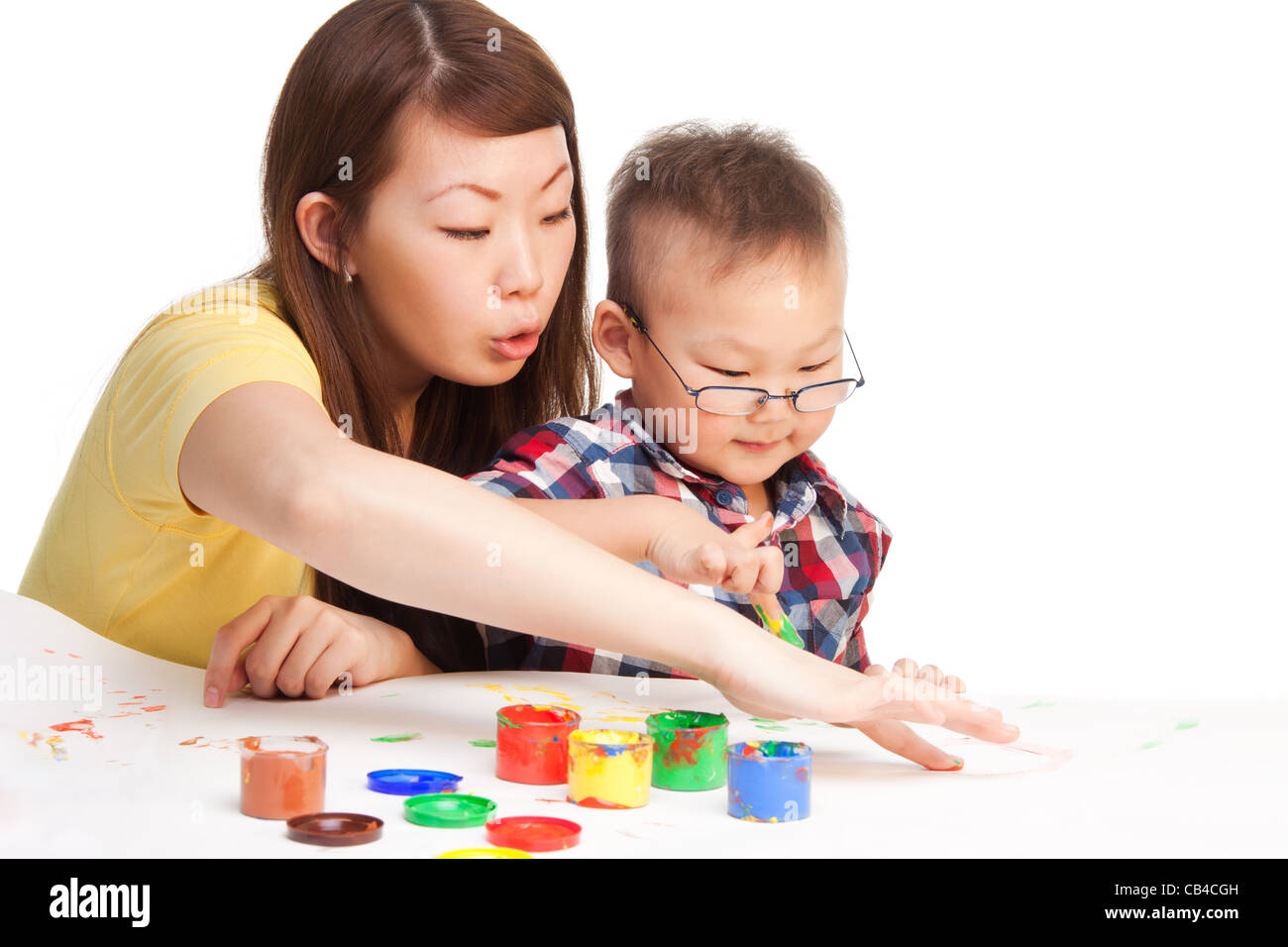 Mother teaches little her Chinese boy how to paint Stock Photo