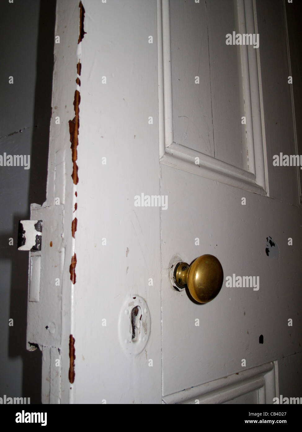 Loose brass handle on old panelled wooden door Stock Photo Alamy