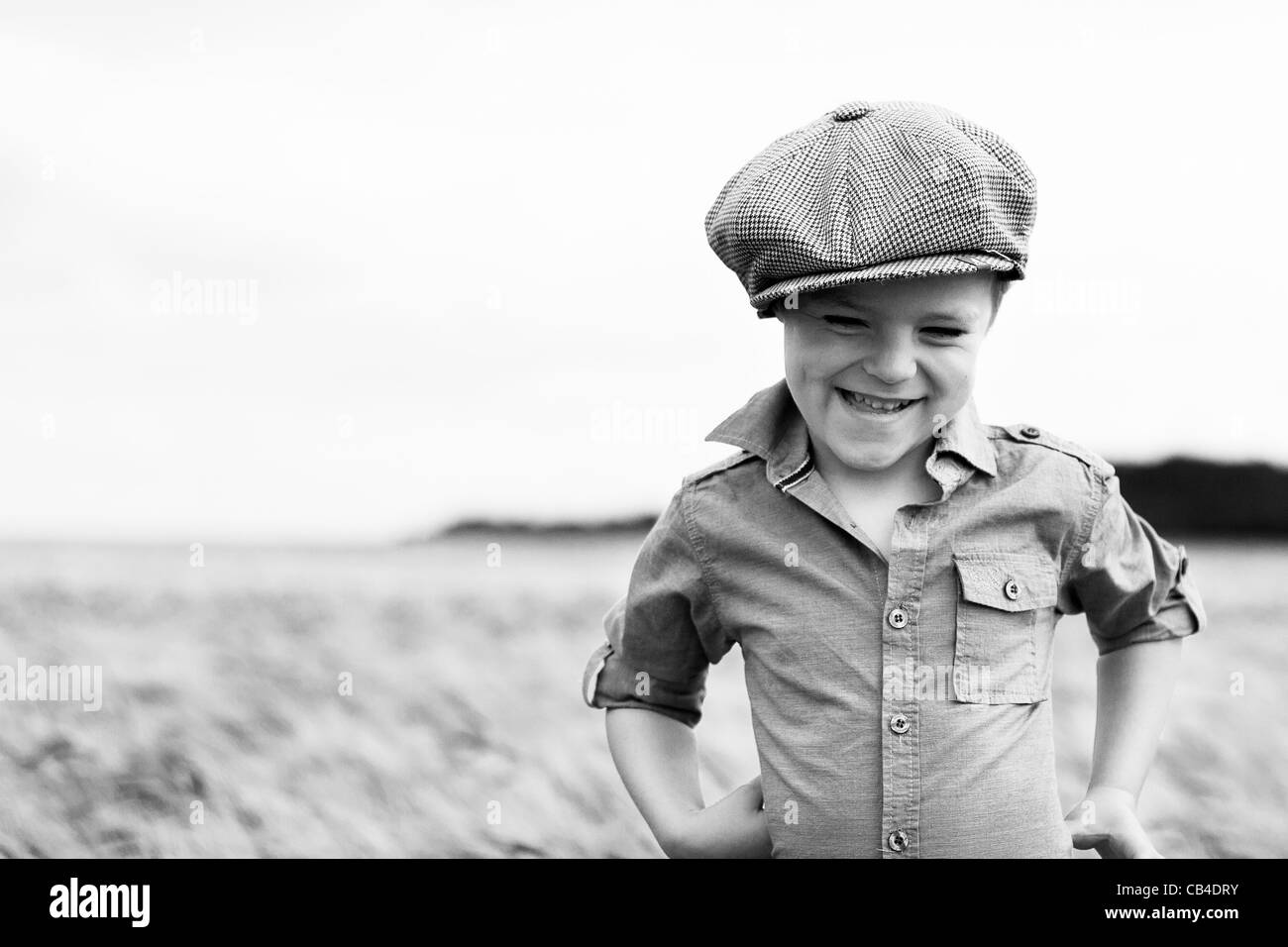 Young Farm Boy playing in a corn field , Yorkshire Wolds , England . Stock Photo