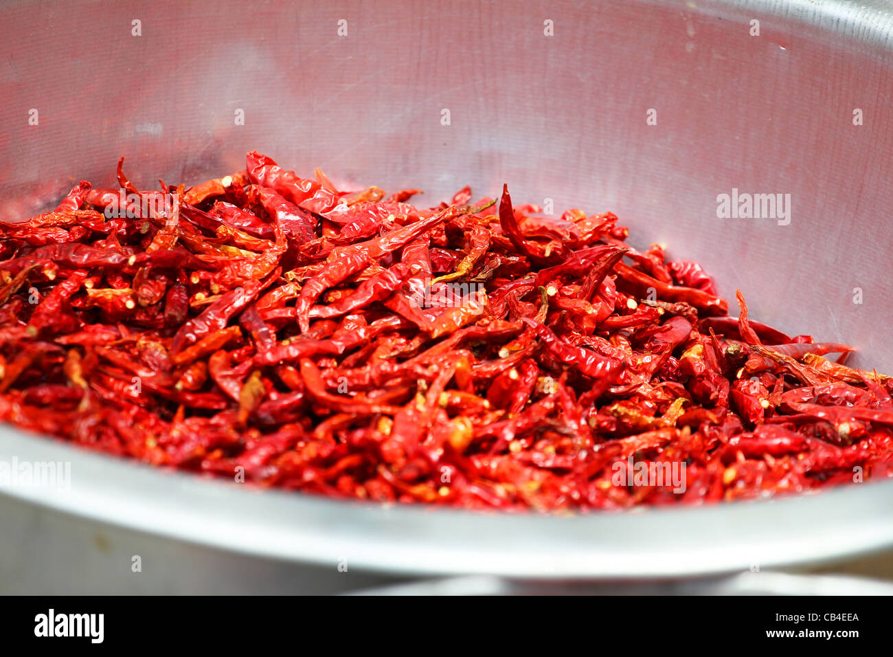 Chili peppers drying in the sun in Thailand. Stock Photo