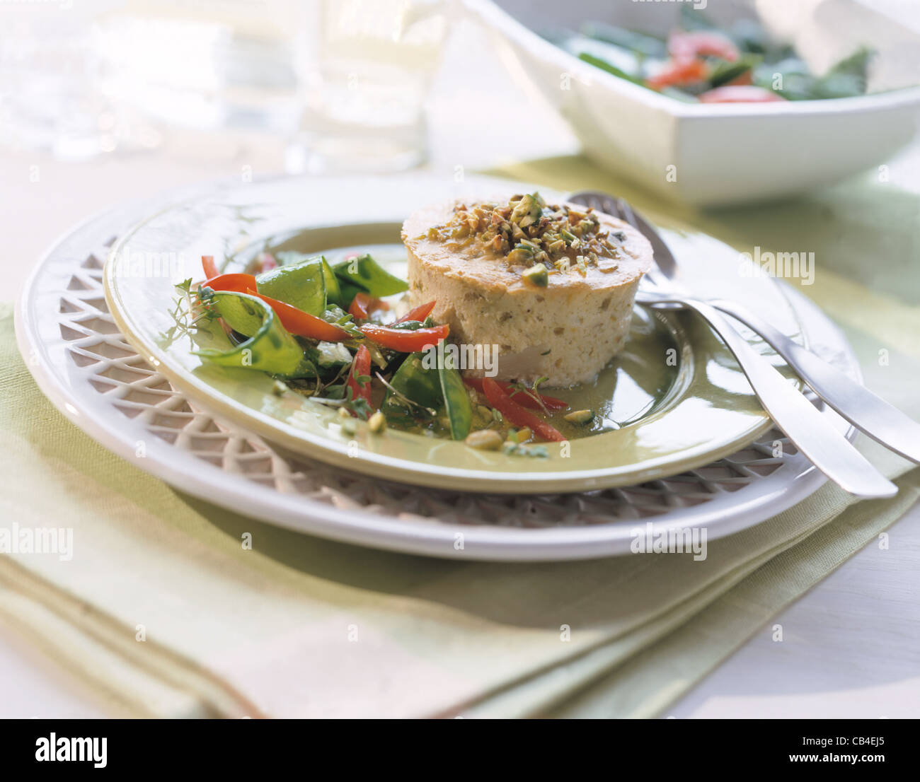 Pistachio asparagus flan with sugar pea salad Stock Photo
