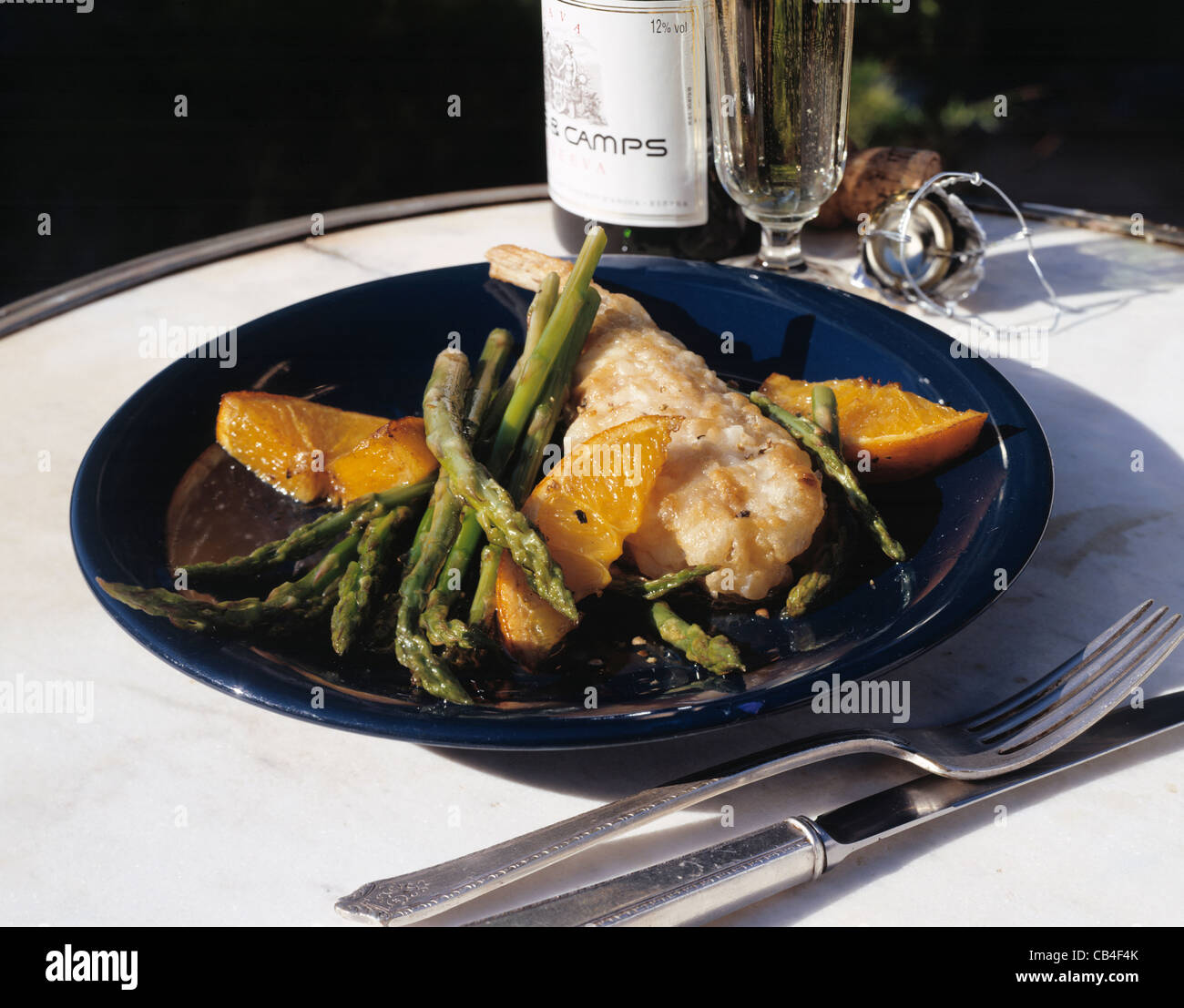 Monk fish with oranges and green asparagus Stock Photo