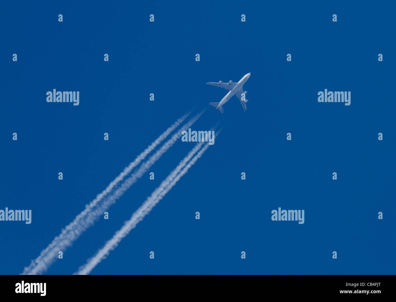 Aircraft with condensation trail Stock Photo
