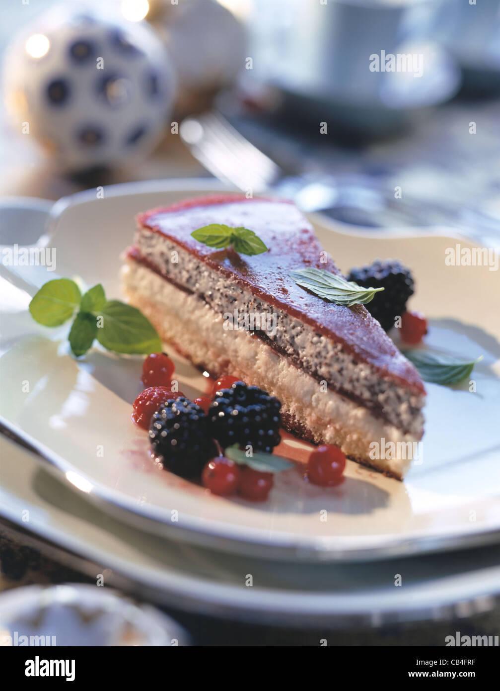 Poppy seed mousse with cassis jelly and rum fruits (tart Stock Photo Alamy