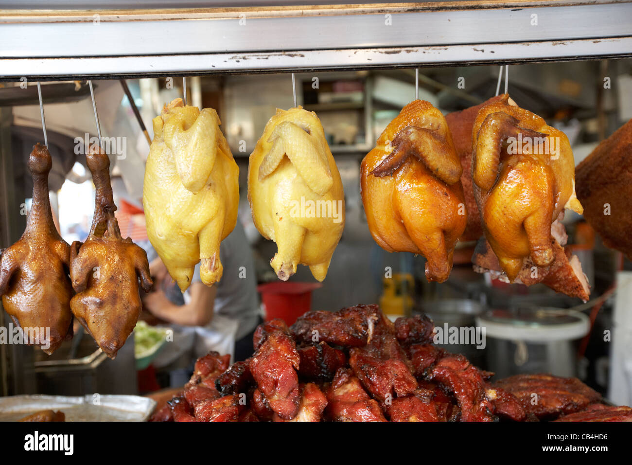siu mei roasted meats hanging in a takeaway window kowloon hong kong china Stock Photo