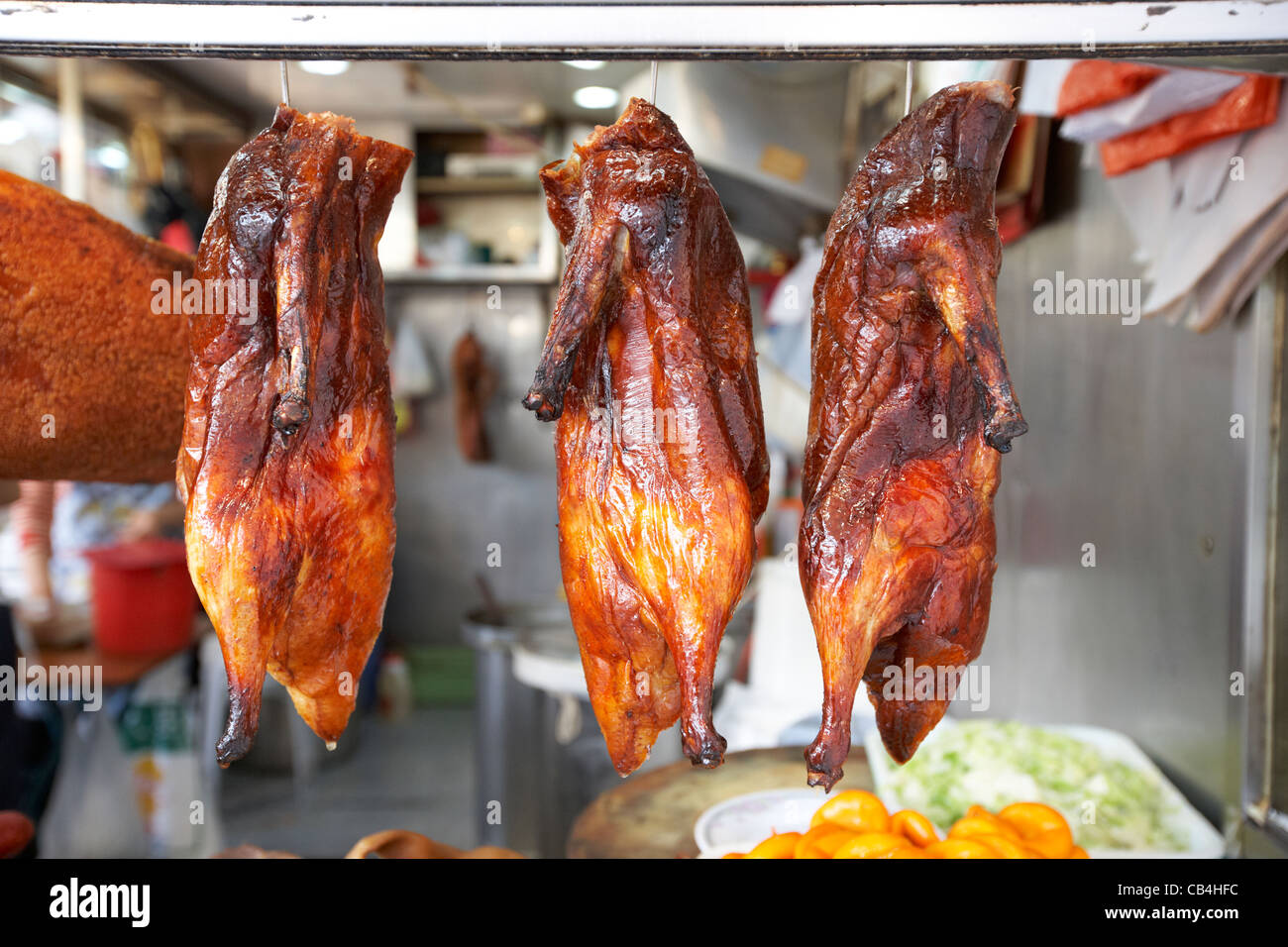siu mei roasted goose hanging in a takeaway window kowloon hong kong china Stock Photo