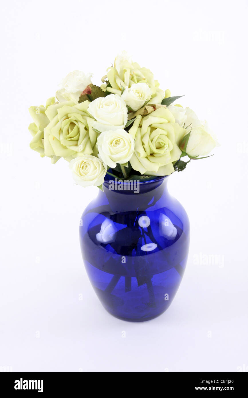 A blue vase full of a bouquet of roses Stock Photo - Alamy