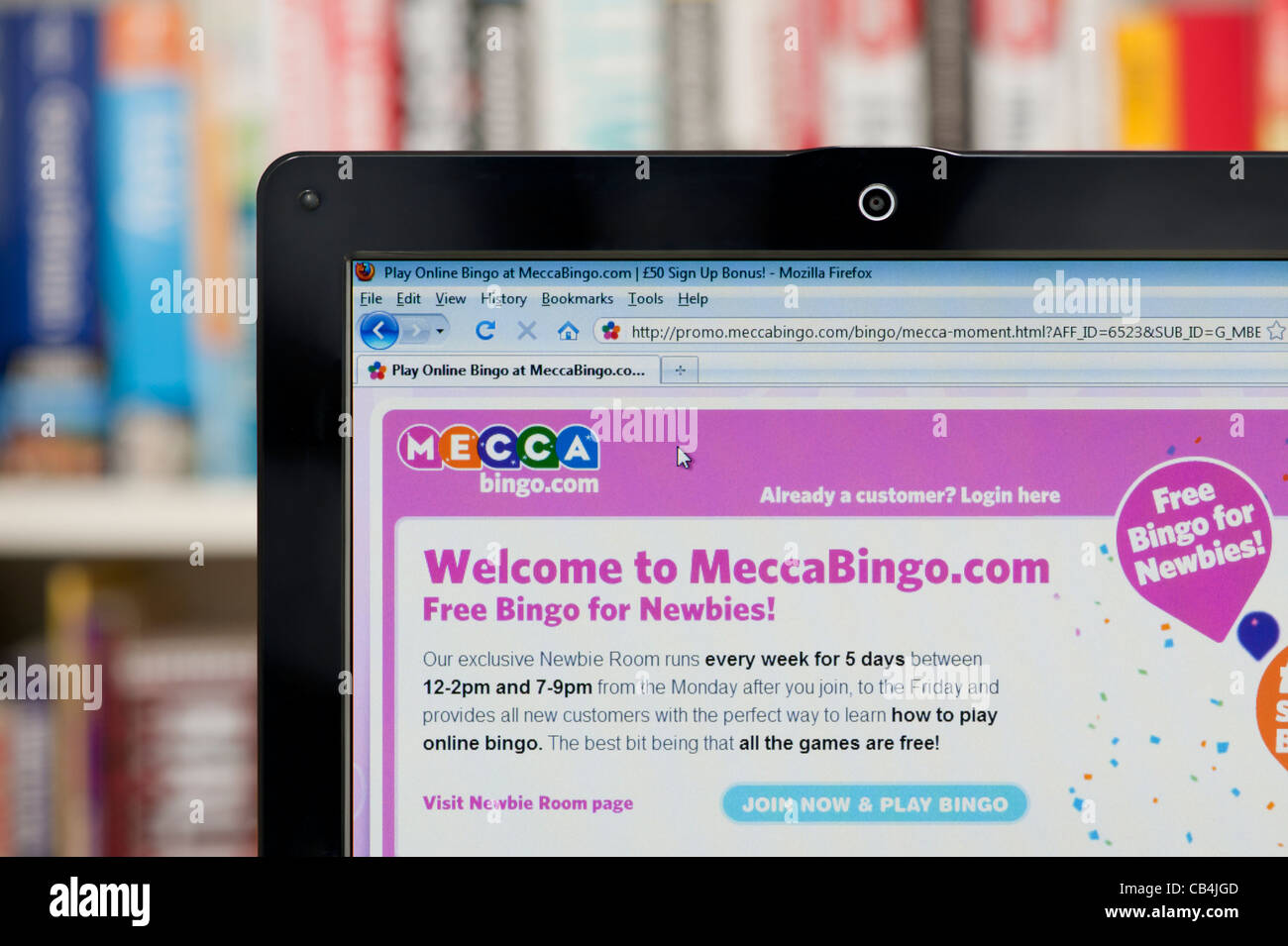The Mecca Bingo website shot against a bookcase background (Editorial use only: print, TV, e-book and editorial website). Stock Photo