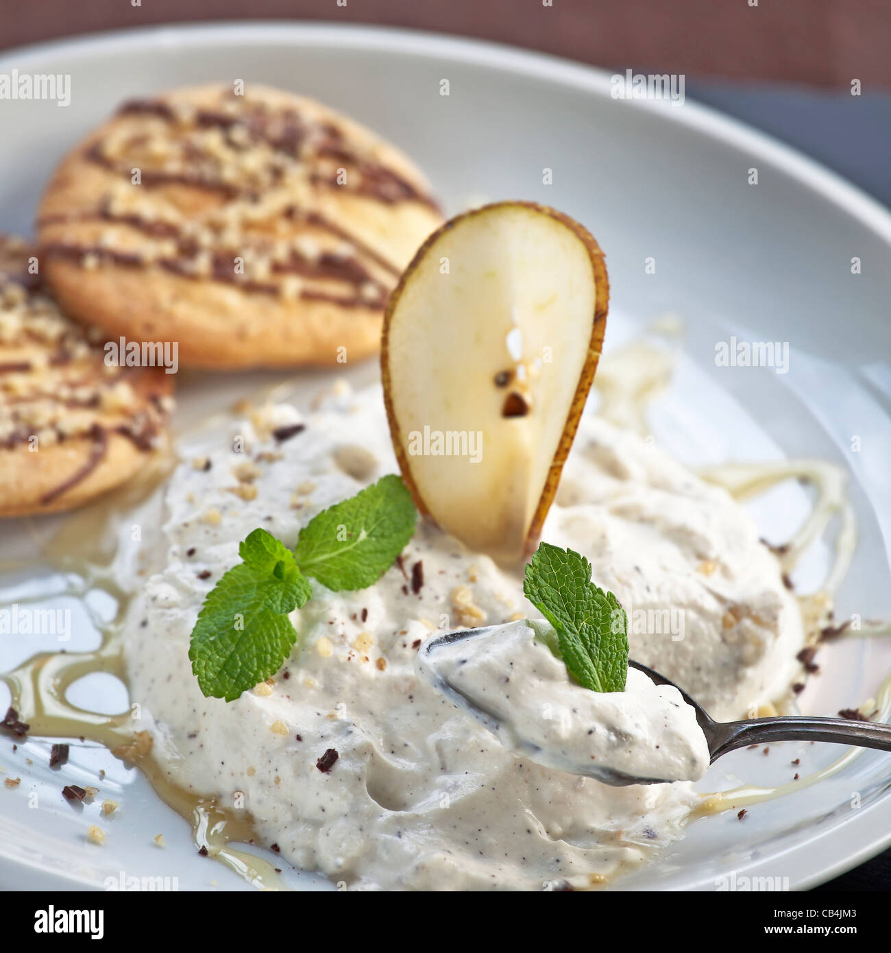 Pear mousse, cream, ricotta and honey Stock Photo