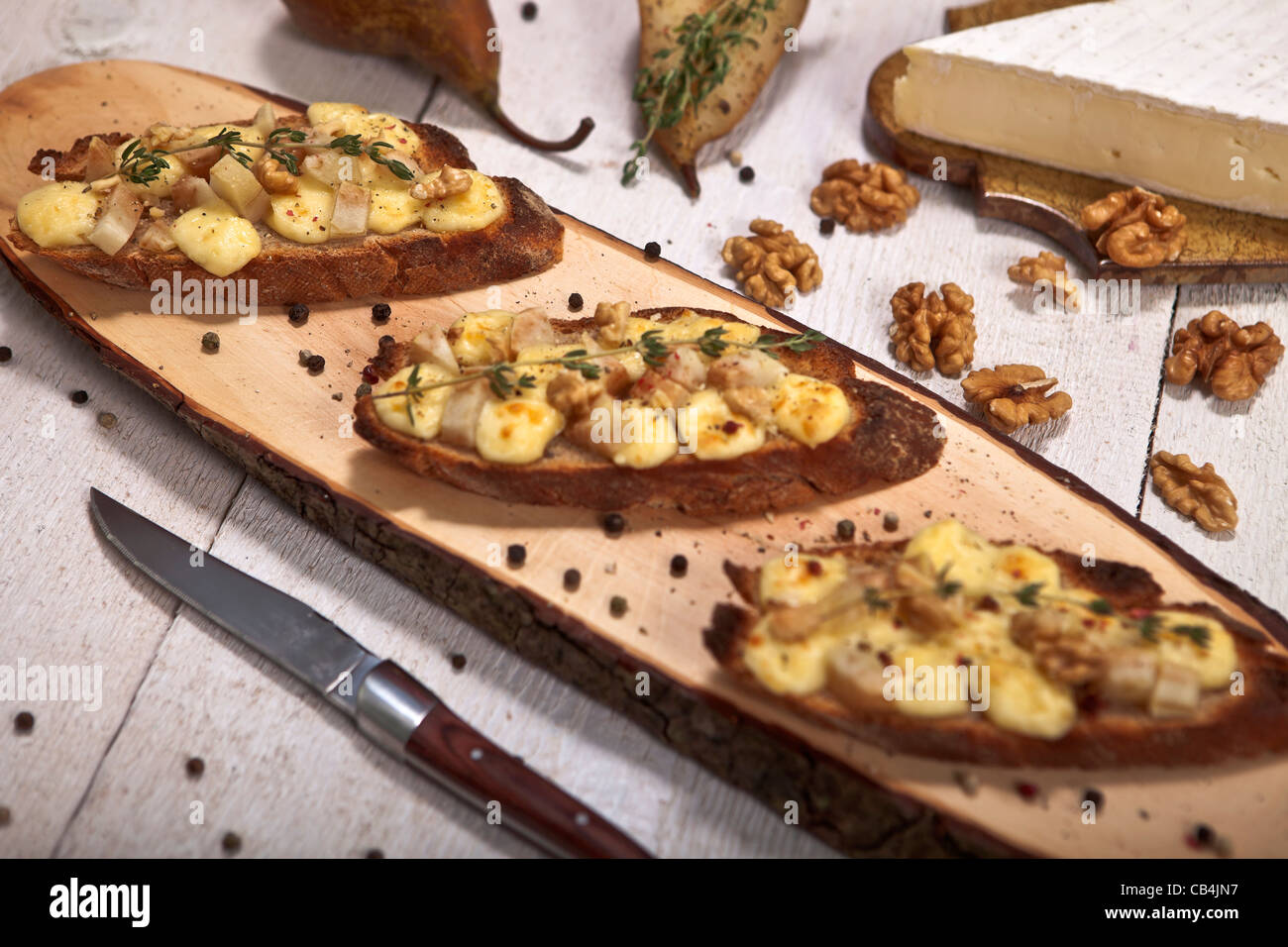 as an appetizer or snack: rye bread with soft cheese such as Brie and Pear  Stock Photo