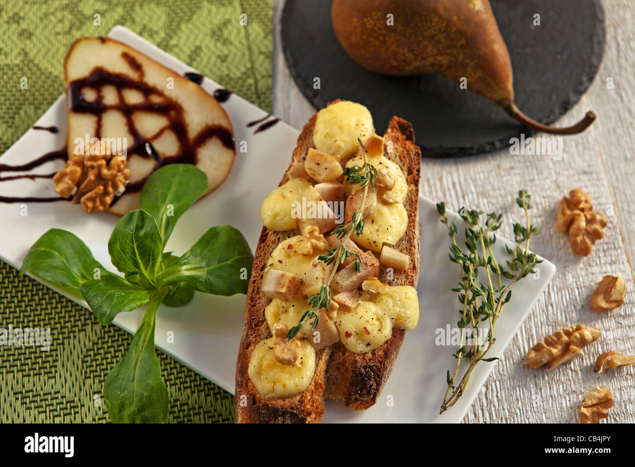 as an appetizer or snack: rye bread with soft cheese such as Brie and Pear  Stock Photo