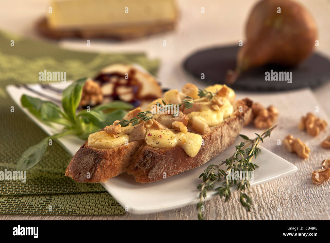 as an appetizer or snack: rye bread with soft cheese such as Brie and Pear  Stock Photo