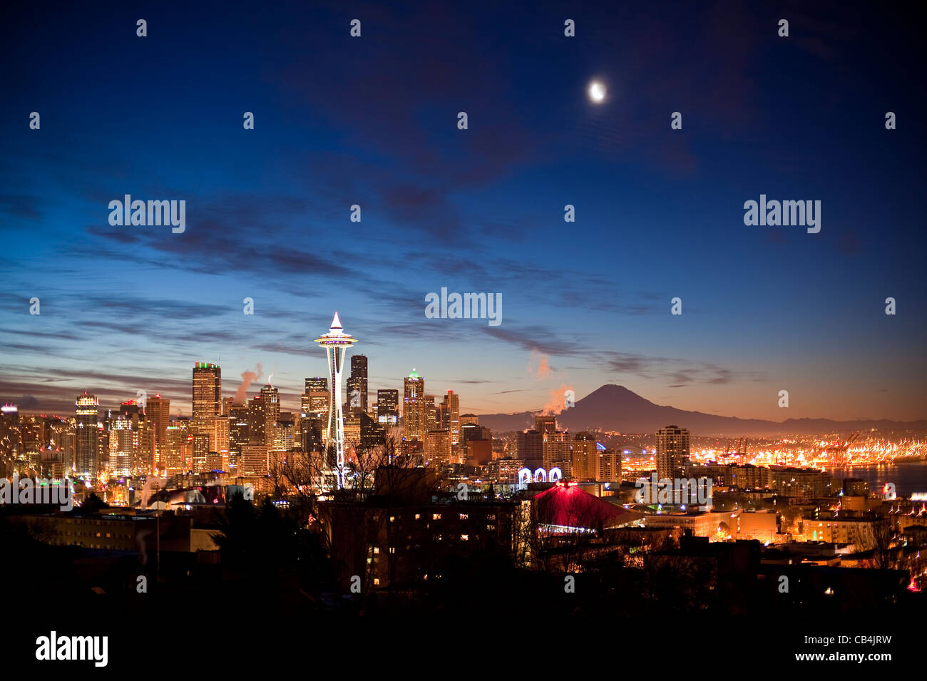 Retro Image of Seattle with moon and Space Needle with Mount Rainier and city lights. Stock Photo