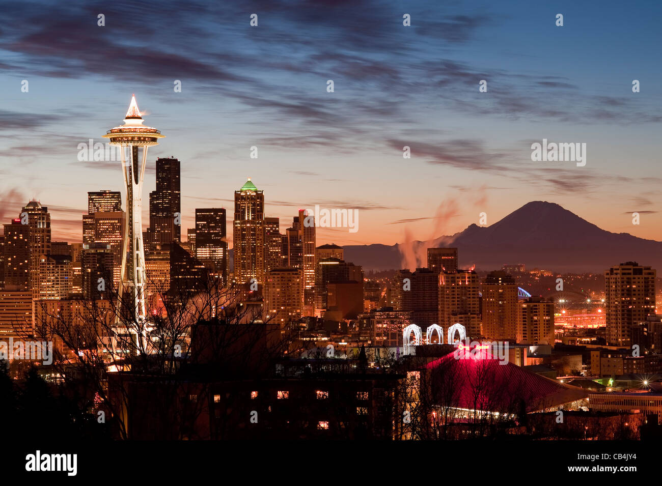 Retro Image of Seattle and Mount Rainier at sunrise with city lights. Stock Photo