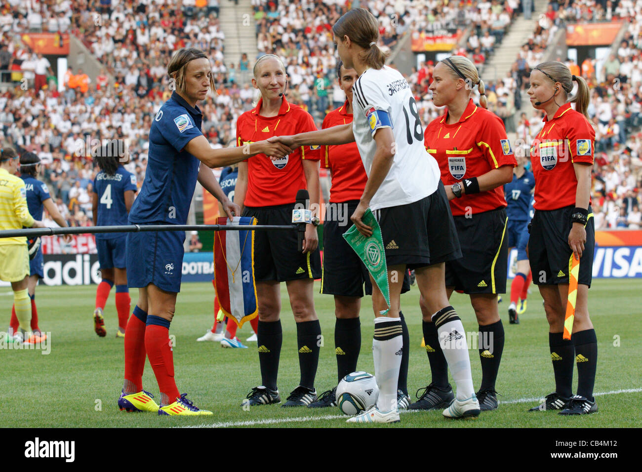 Team captains Sandrine Soubeyrand of France (L) and Kerstin Garefrekes of Germany (R) shake hands before a 2011 World Cup match. Stock Photo