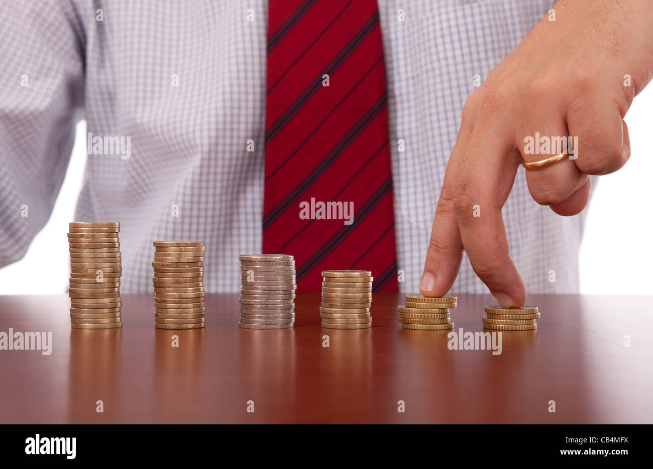 businessman finger walking over money piles Stock Photo