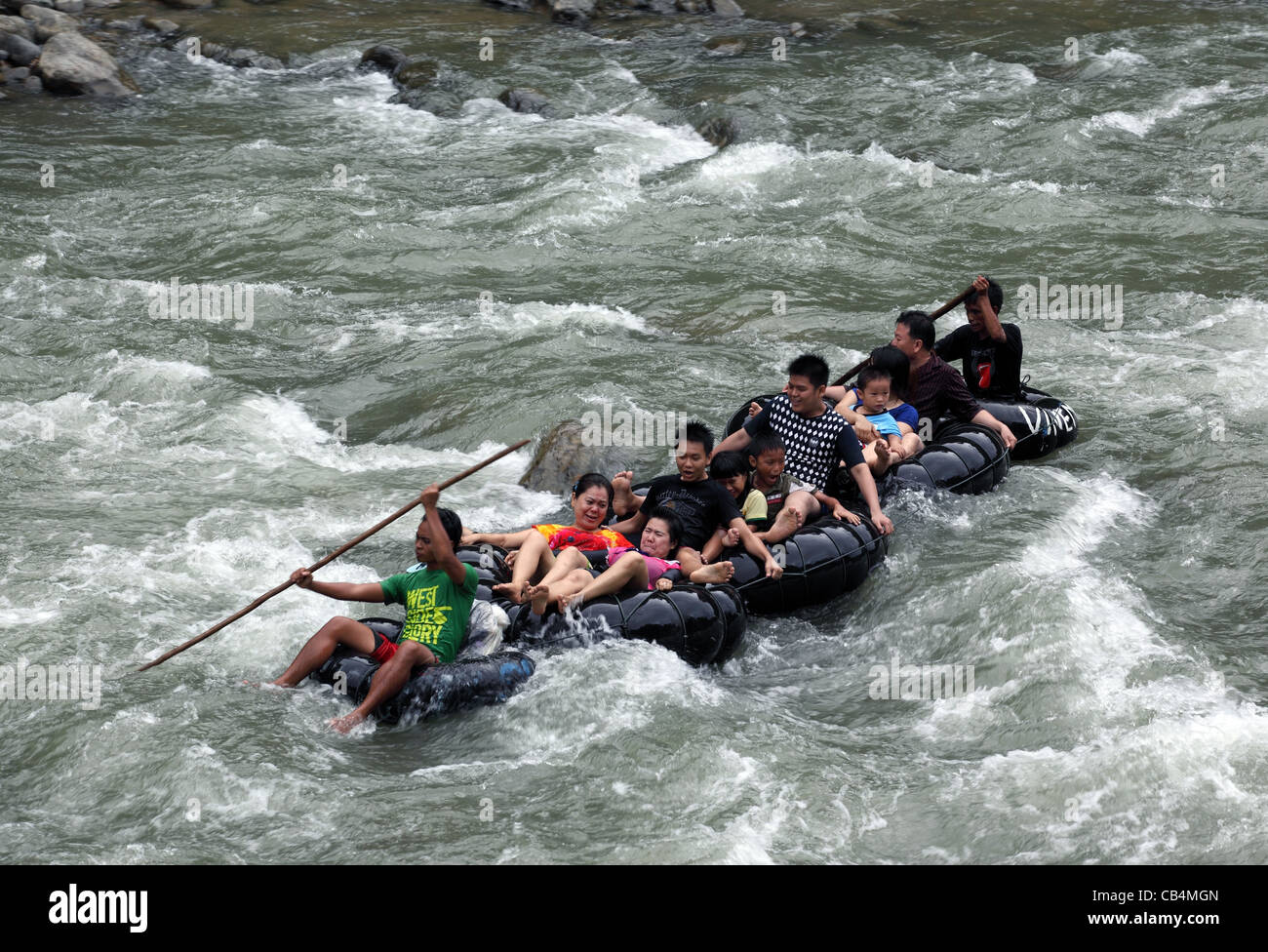 Rafting on connected inner tubes down the Bohorok River. Gunung Leuser National Park, Bukit Lawang, Sumatra, Indonesia, Asia Stock Photo