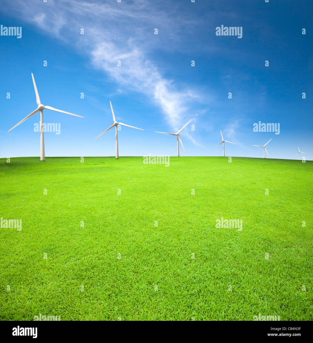 Wind turbines in an green field with cloud background Stock Photo