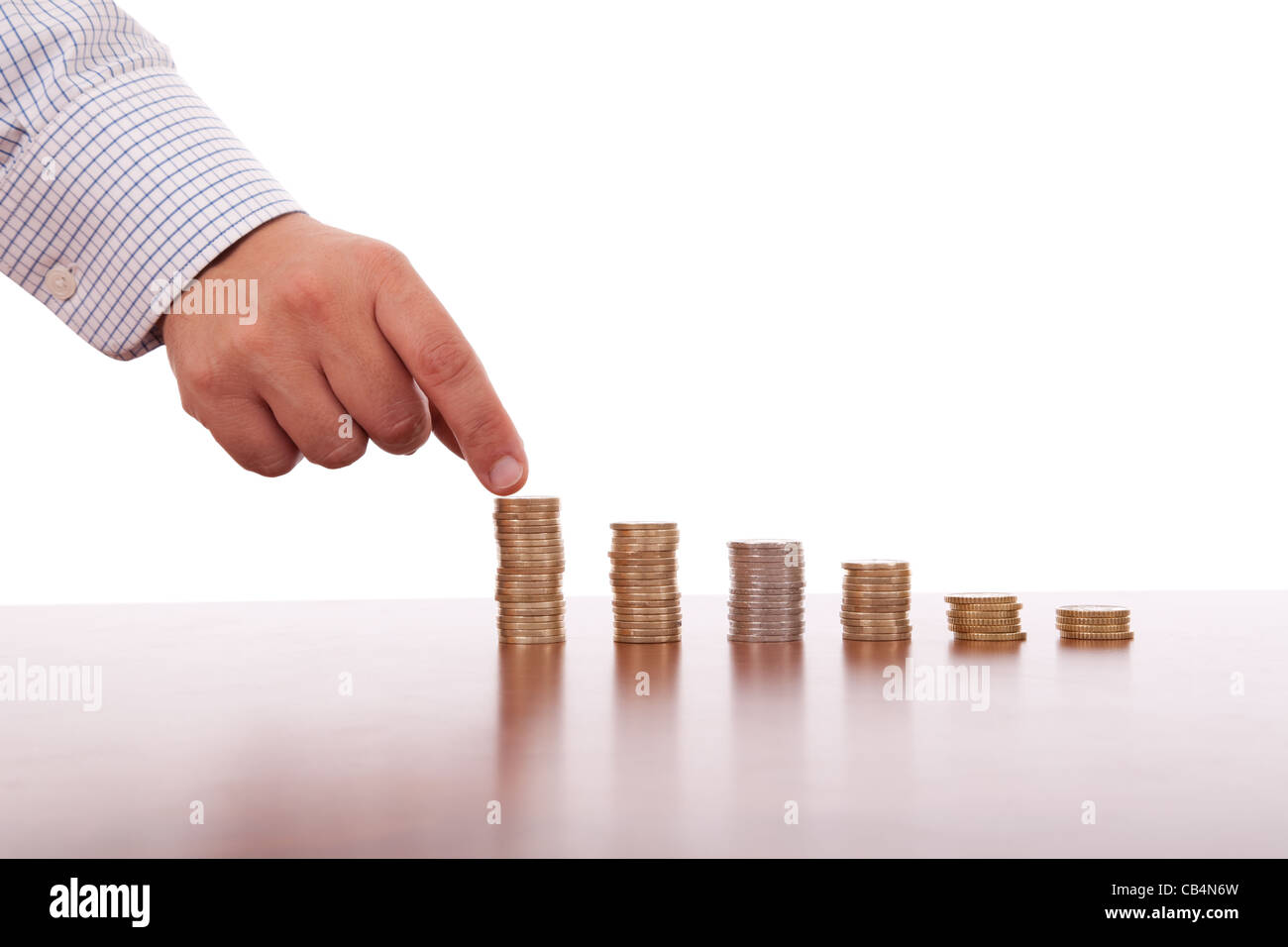 businessman picking a coin in pile of money Stock Photo