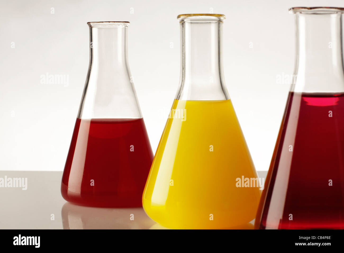close up detail of laboratory beakers with different coloured liquid in