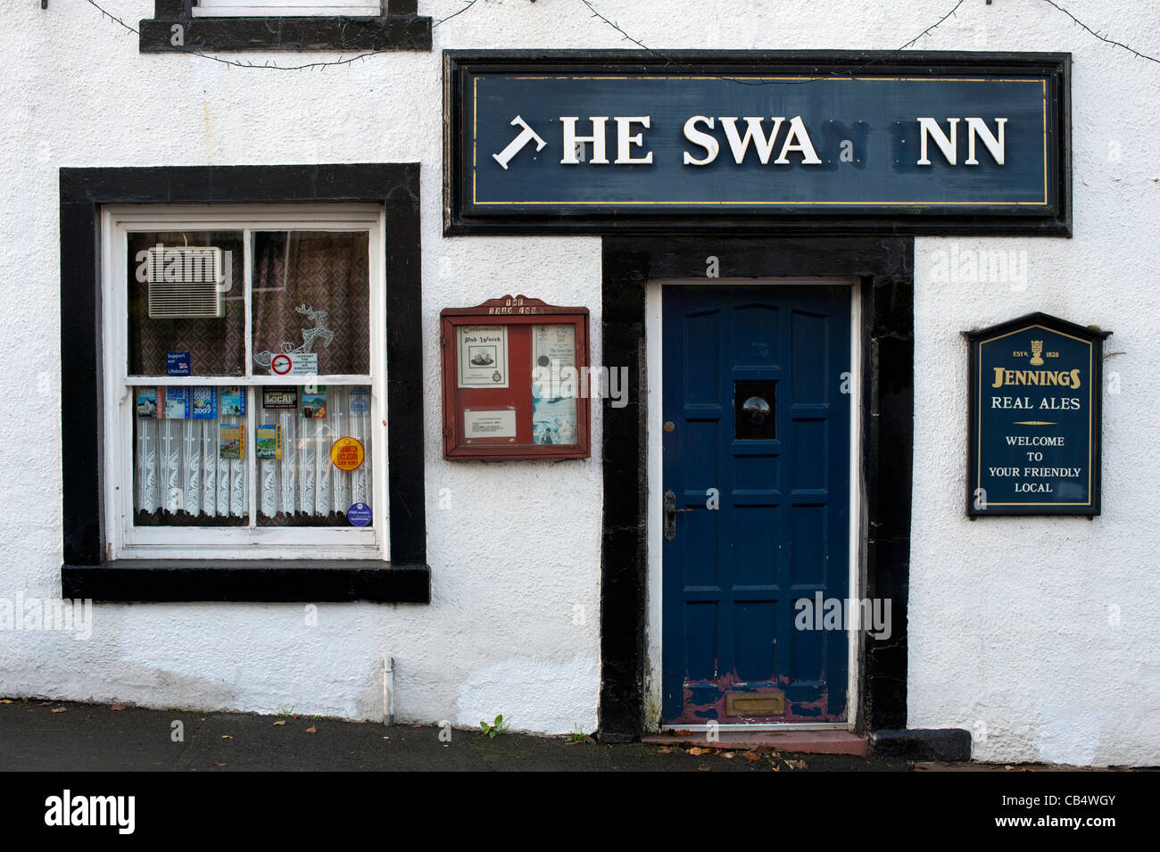The Swan Inn pub front with broken sign Stock Photo