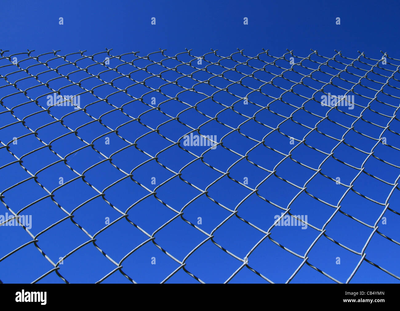 chain link fence against a blue sky Stock Photo
