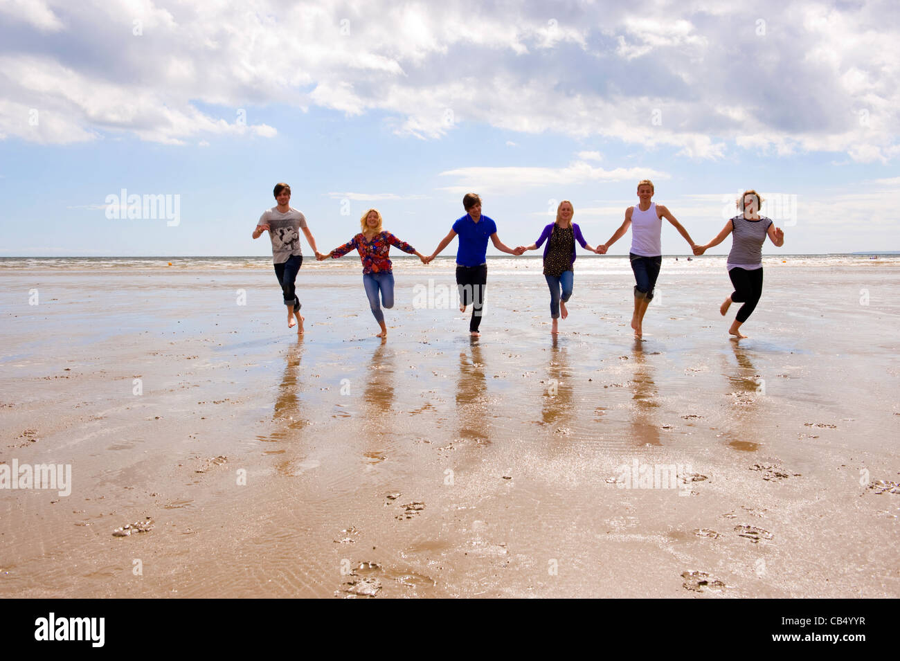 A group of young people camping and having fun at Black Rock Sands in ...