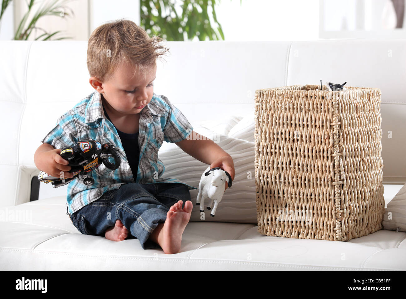 Young boy playing with his toys Stock Photo - Alamy