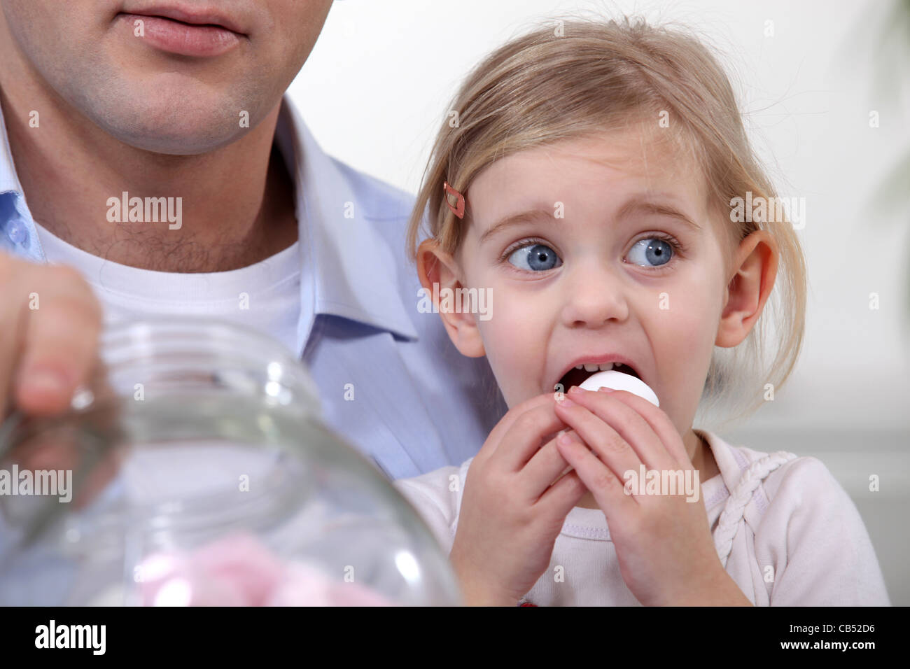 Little girl eating marshmallows Stock Photo Alamy
