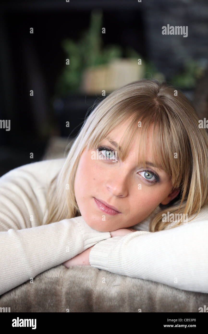 Blond woman relaxing on sofa Stock Photo