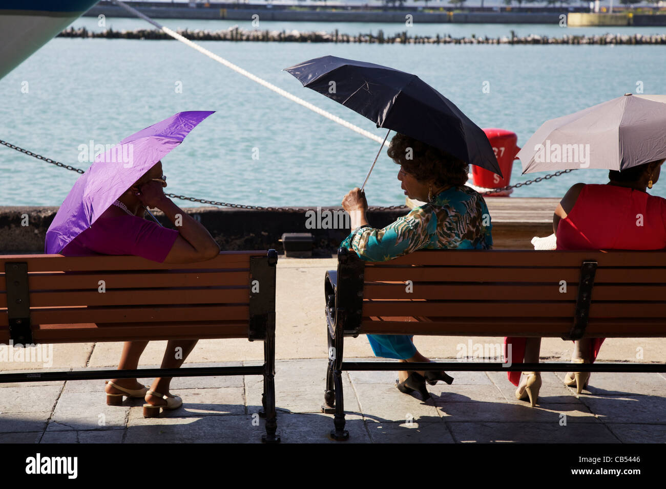Ladies in conversation on a bench on Chicago's Navy Pier. Stock Photo