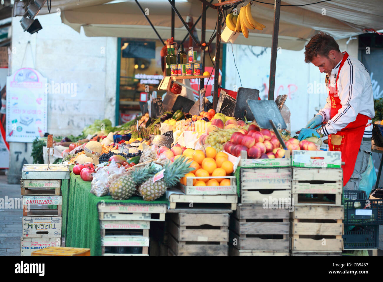 A fruiterer with his stall in the street in Venice, Italy. Street stalls and open-air markets are a feature of life in the city. Stock Photo
