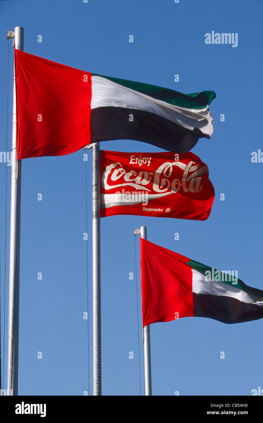 UAE national flag and Coca Cola flags flying at bottling plant