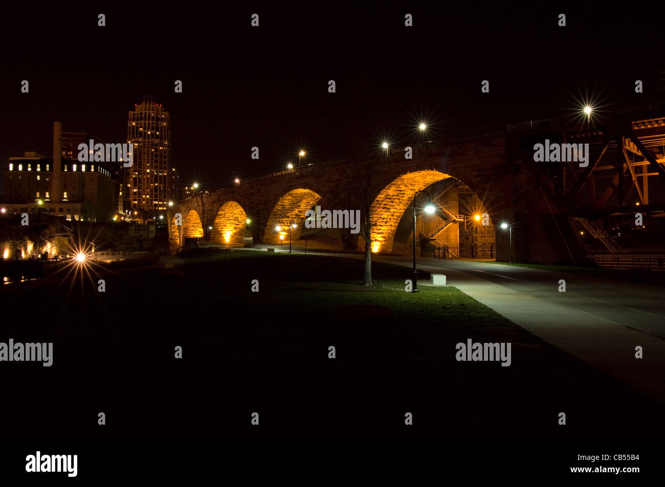 Stone Arch Bridge at night under lights and Mill City Ruins in downtown Minneapolis Minnesota