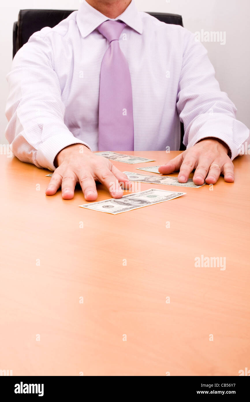 businessman grabbing a dollar bill in his desk (selective focus Stock