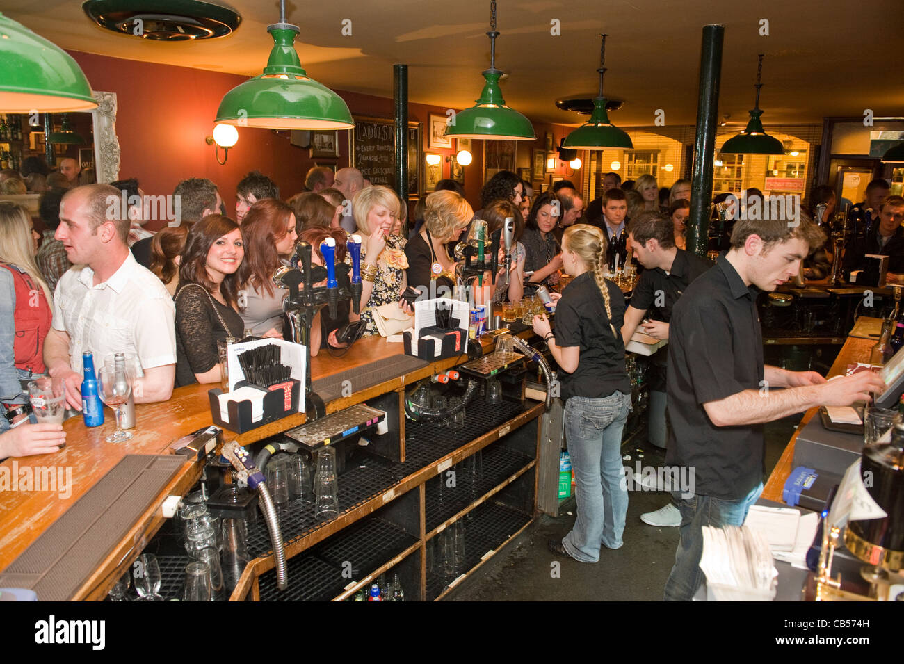 Busy bar filled with young males and females Stock Photo Alamy