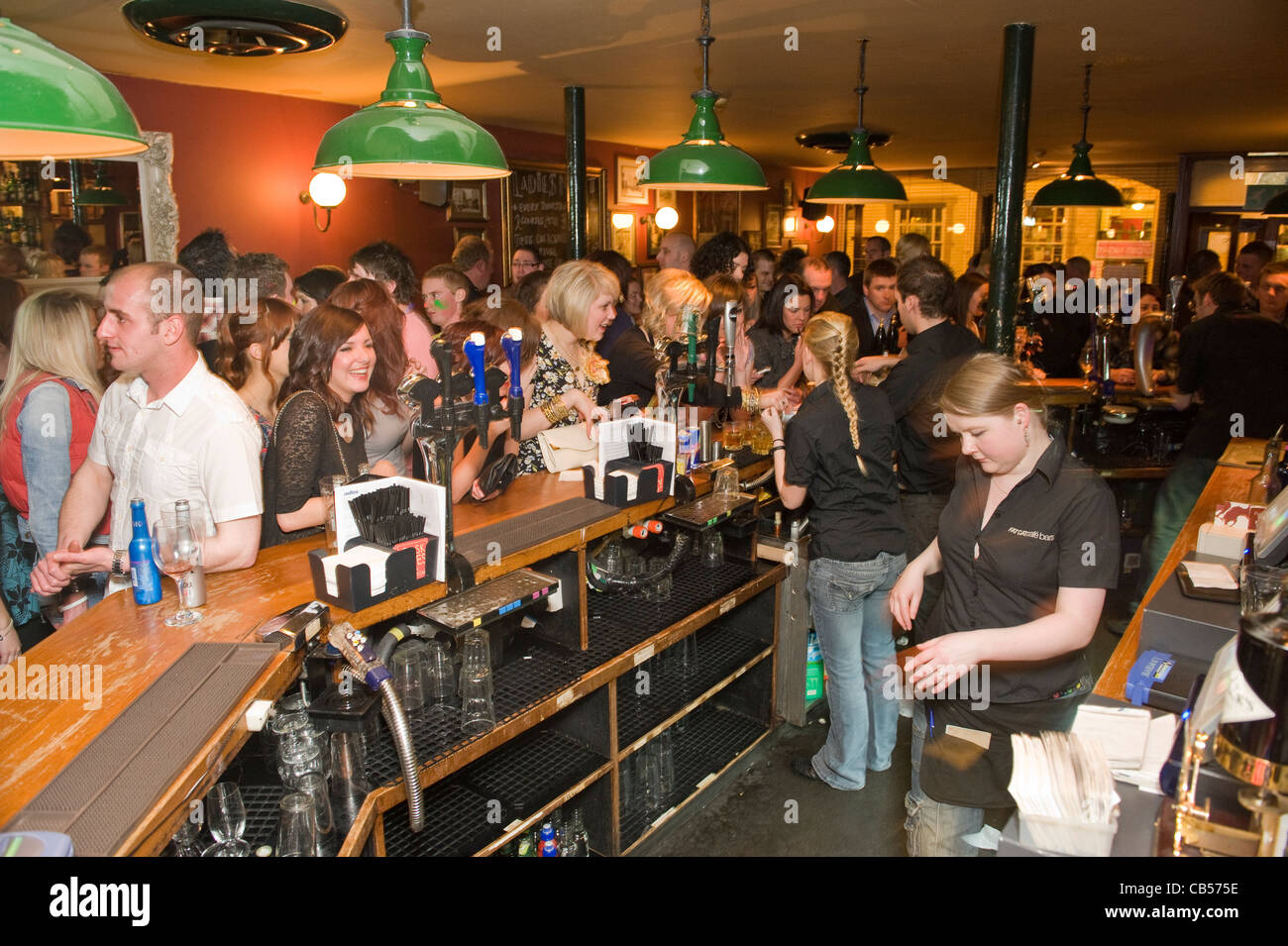 Busy bar filled with young males and females. Stock Photo