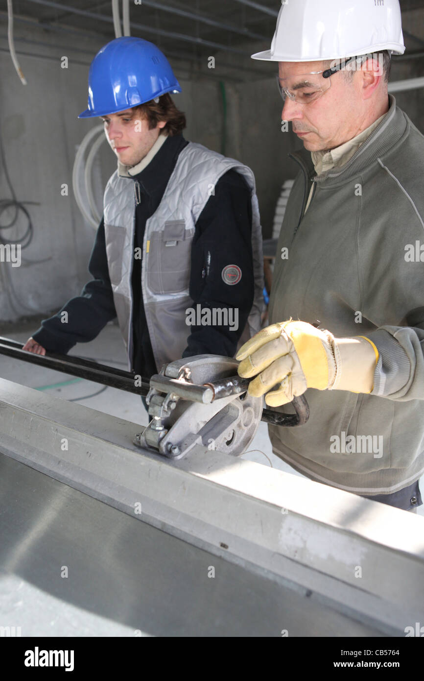 Workers on construction site Stock Photo - Alamy