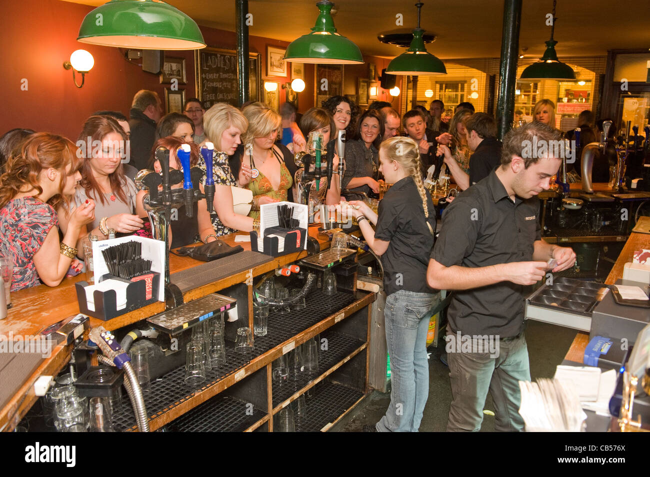 Busy bar filled with young males and females Stock Photo Alamy