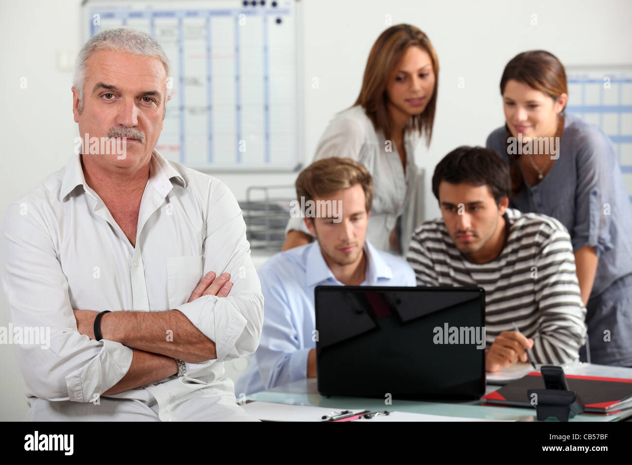 People looking at a computer Stock Photo - Alamy