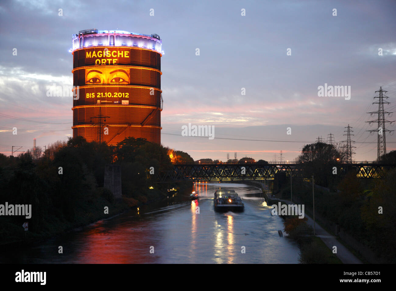 Rhine-Herne canal, inland waterway. Gasometer, a big gas holder, today an exhibition and cultural event location. Stock Photo