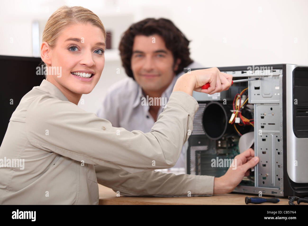 Happy technician fixing a computer Stock Photo Alamy